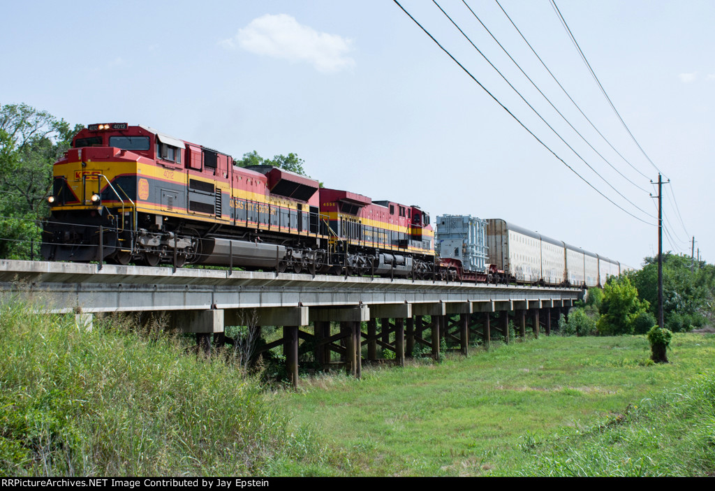 A KCS manifest crosses a low bridge north of Ganado, Texas